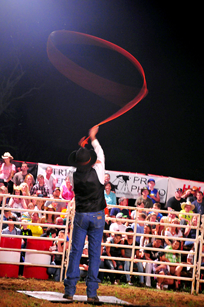 A cowboy swings lis lasso high during the Red Gate Rodeo in Maynardville, TN