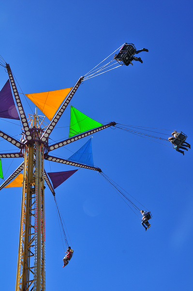 A swing tosses riders high duing the Tennessee State Fair