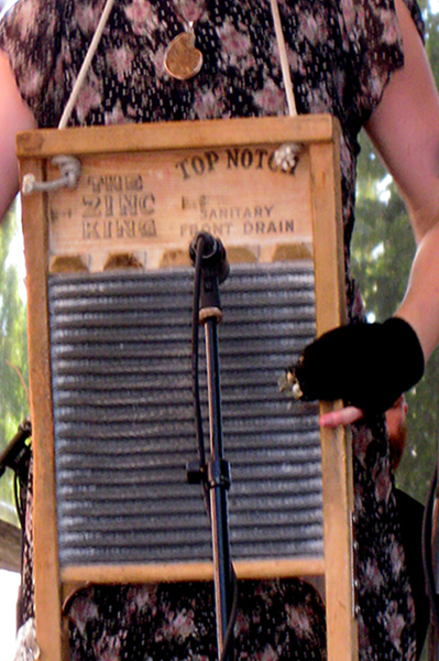 Close up of a woman playing the washboard