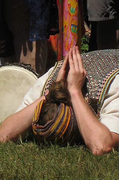 A man bows down to reflect duing the Opening Water Ceremony at the Oregon Country Fair